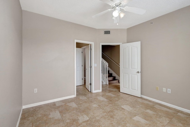 unfurnished bedroom featuring ceiling fan