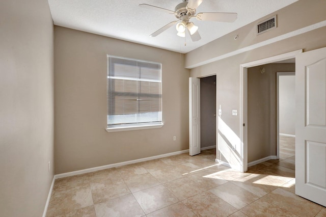 unfurnished bedroom with light tile patterned floors, a closet, and ceiling fan