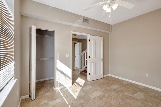 unfurnished bedroom featuring light tile patterned floors, a closet, and ceiling fan