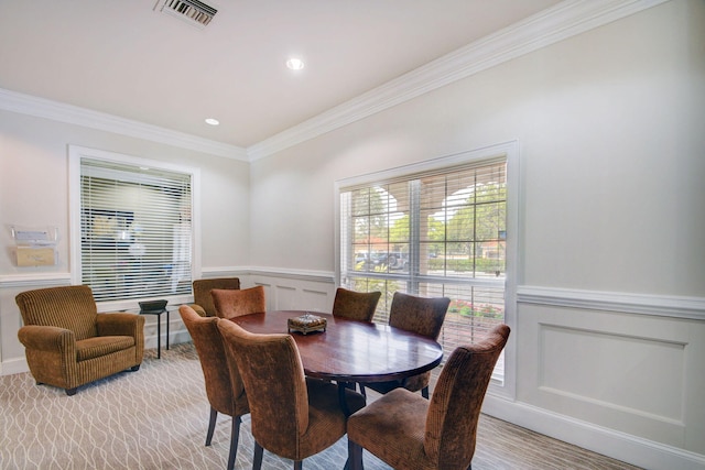 dining space with ornamental molding