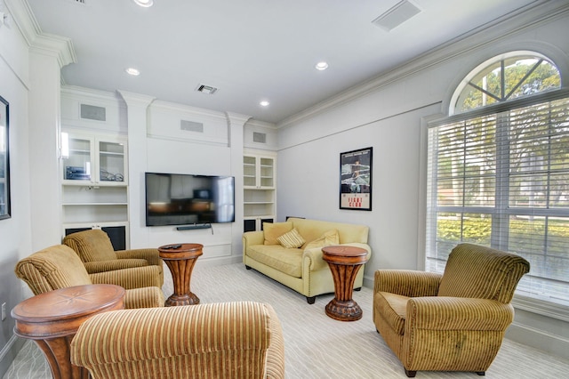 living room featuring ornamental molding and built in features