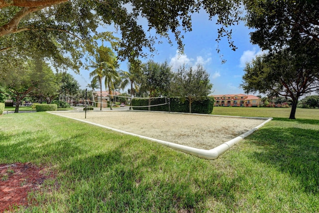 view of property's community with volleyball court and a lawn