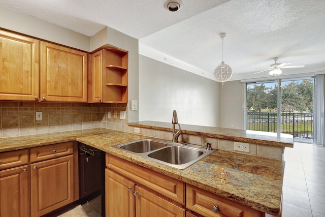 kitchen with pendant lighting, dishwasher, sink, and kitchen peninsula