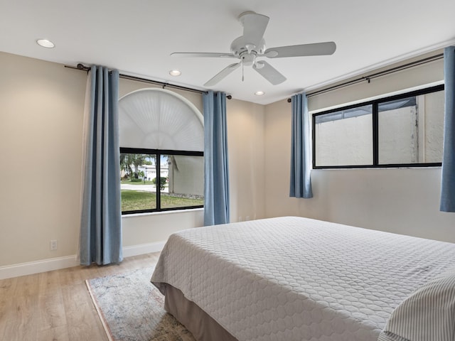 bedroom featuring light hardwood / wood-style floors and ceiling fan