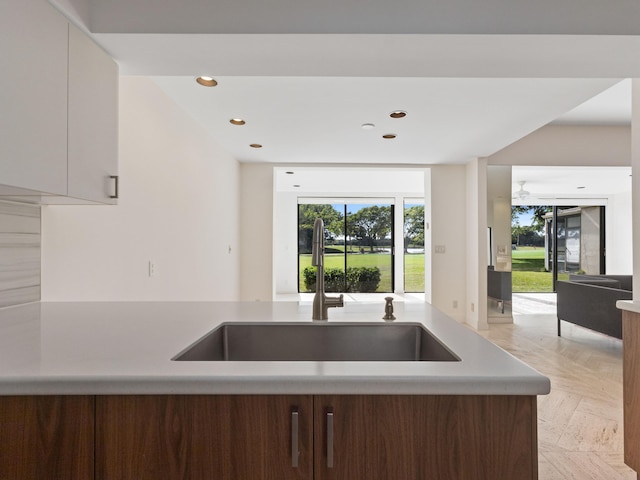 kitchen with white cabinetry and sink