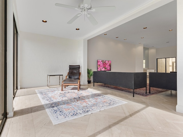 living area featuring light parquet flooring and ceiling fan