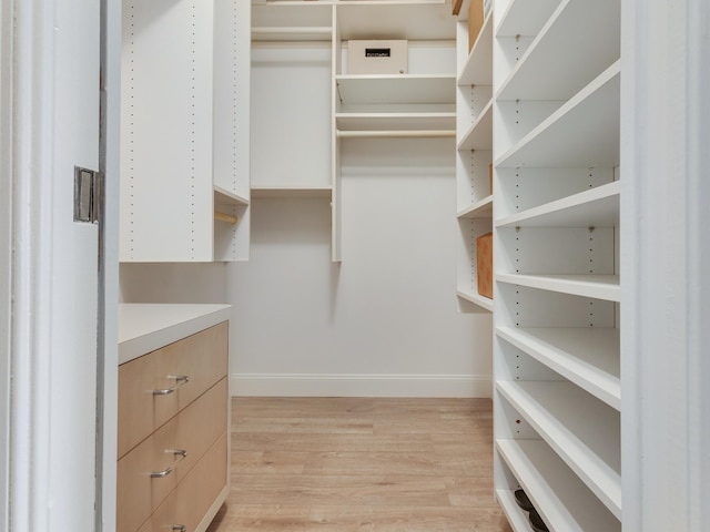 spacious closet featuring light hardwood / wood-style floors