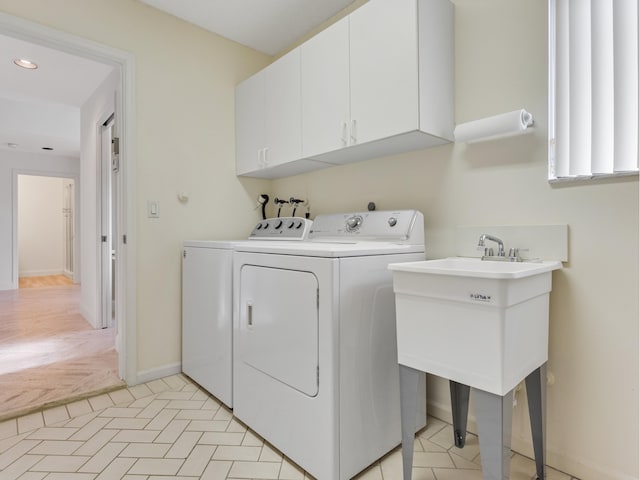 washroom with cabinets and separate washer and dryer