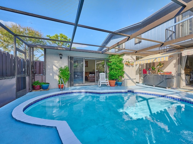 view of swimming pool with a lanai and a patio