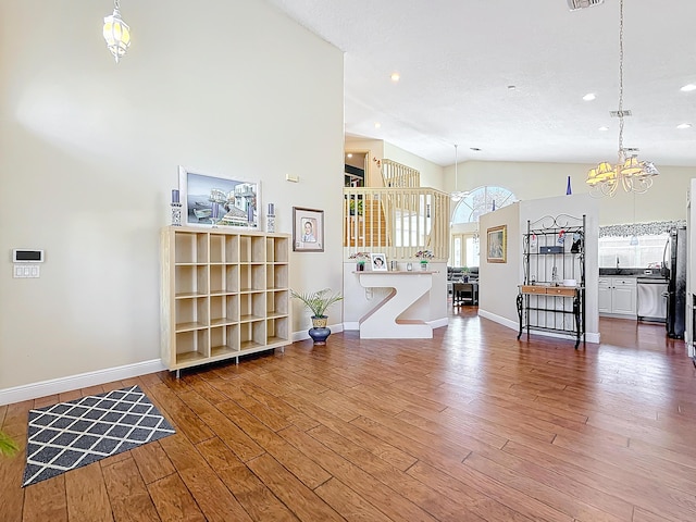 living room with vaulted ceiling, dark wood-type flooring, and sink