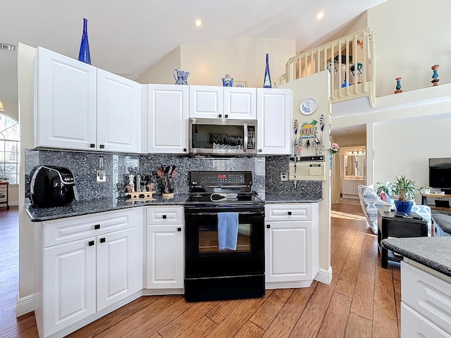 kitchen featuring light hardwood / wood-style flooring, dark stone countertops, electric range, tasteful backsplash, and white cabinets