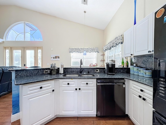 kitchen with pendant lighting, white cabinetry, sink, dark stone counters, and black appliances