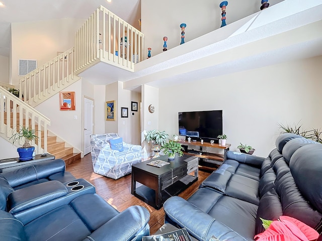 living room with a high ceiling and hardwood / wood-style floors