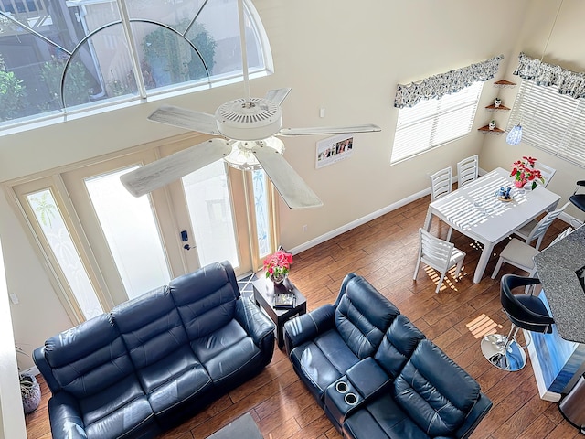 living room featuring dark wood-type flooring and a high ceiling