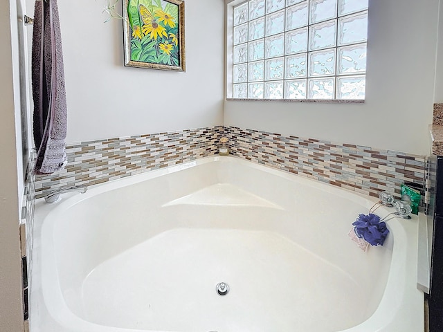 bathroom with a tub to relax in