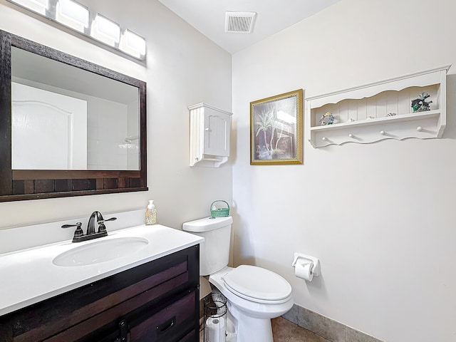 bathroom with tile patterned floors, vanity, and toilet