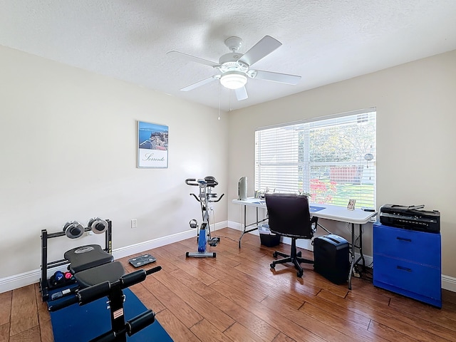 office space with ceiling fan, wood-type flooring, and a textured ceiling