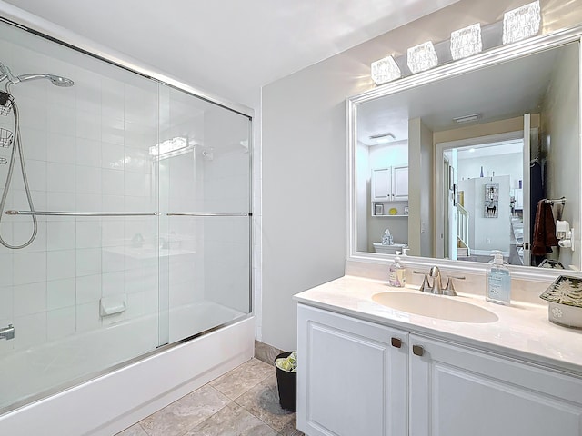 bathroom featuring vanity and bath / shower combo with glass door