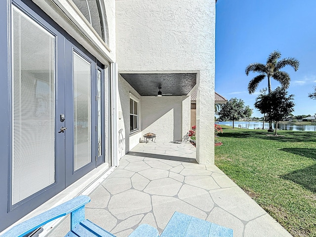 view of patio / terrace with a water view and ceiling fan