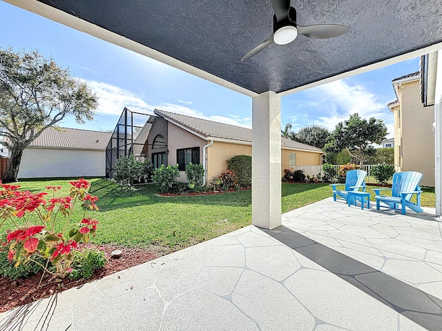 view of patio featuring ceiling fan and a lanai