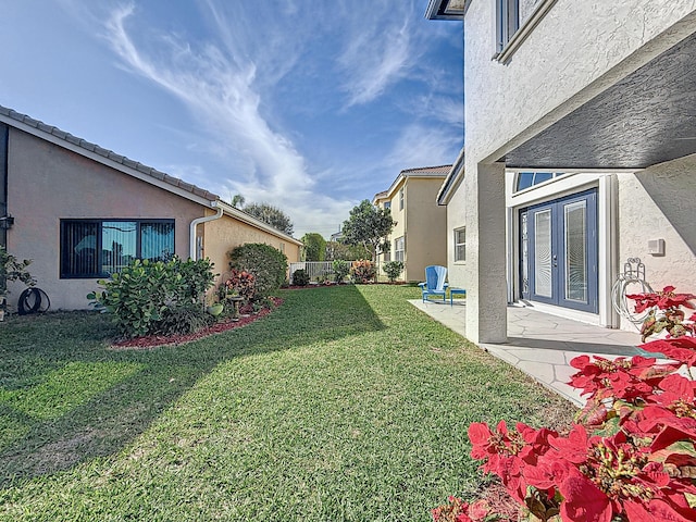 view of yard with a patio and french doors