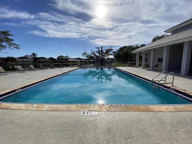 view of swimming pool with a patio