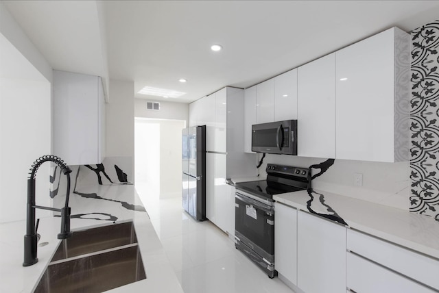kitchen with white cabinetry, stainless steel appliances, and sink