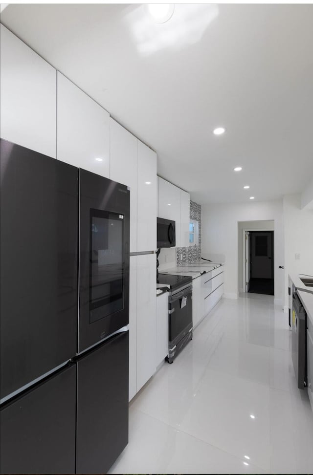 kitchen featuring black electric range and white cabinets