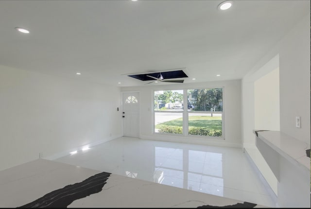 interior space featuring light tile patterned floors and ceiling fan