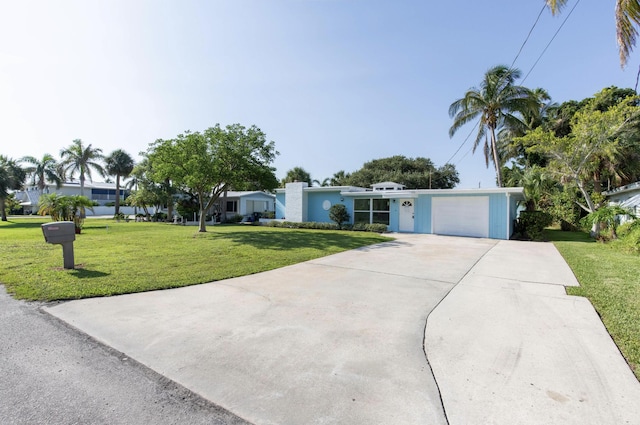 ranch-style home featuring a garage and a front lawn