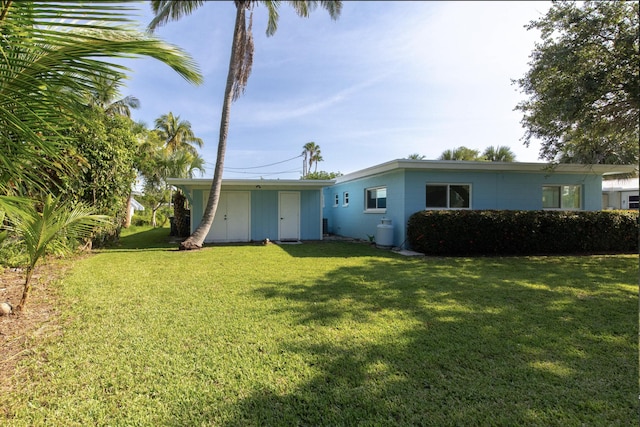 back of house with a yard