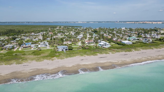 birds eye view of property featuring a view of the beach and a water view