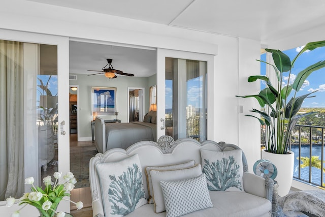 interior space with a water view and ceiling fan