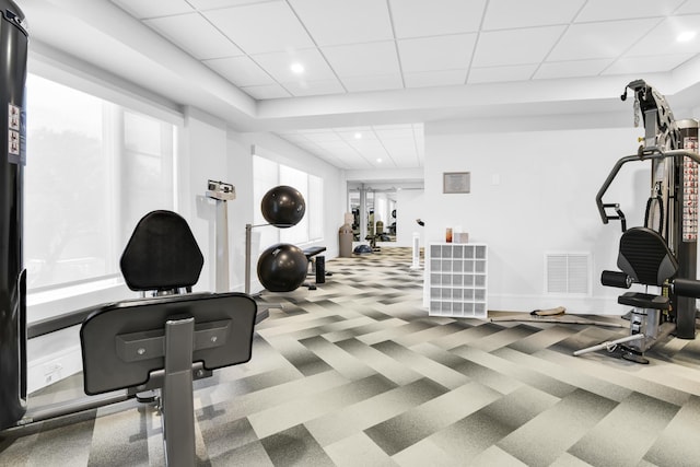 exercise room with a wealth of natural light and a paneled ceiling