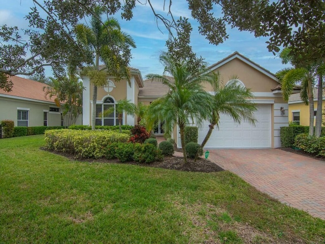 view of front of property with a garage and a front yard