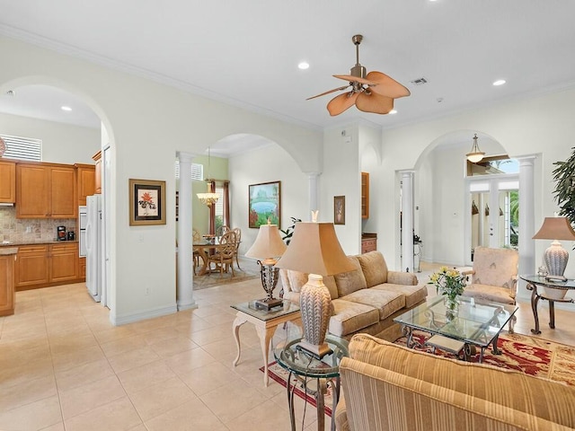 tiled living room featuring decorative columns, ornamental molding, and ceiling fan