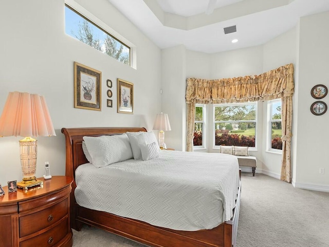 bedroom with a high ceiling and carpet flooring