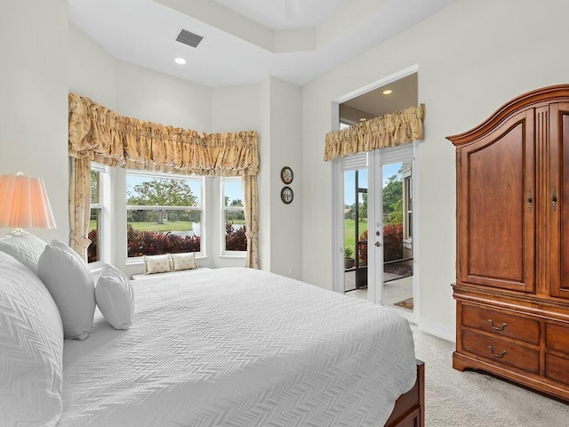 bedroom with light carpet and access to outside