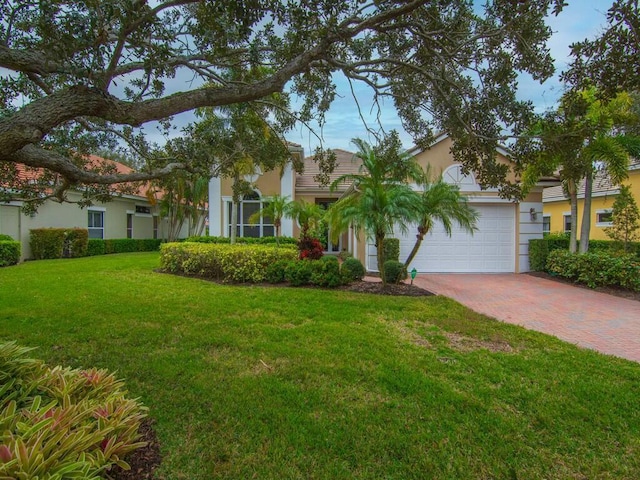 view of front of home featuring a garage and a front yard