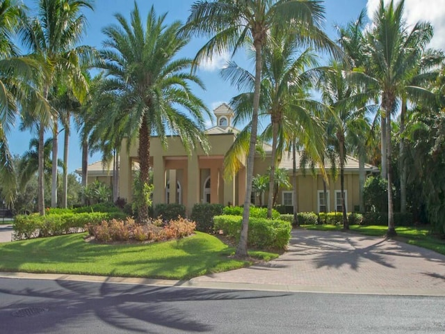 mediterranean / spanish-style home with a front yard