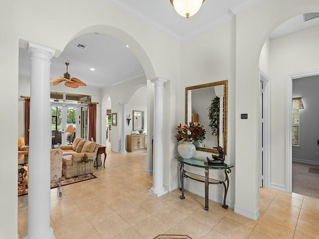 hallway featuring ornamental molding, light tile patterned floors, and ornate columns