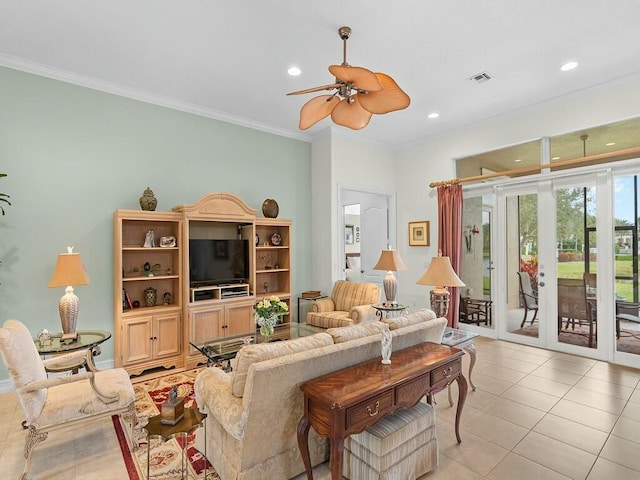 living room with light tile patterned flooring, ornamental molding, and ceiling fan