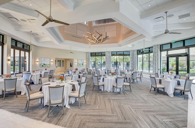 carpeted dining room featuring ceiling fan with notable chandelier, french doors, beamed ceiling, and a high ceiling