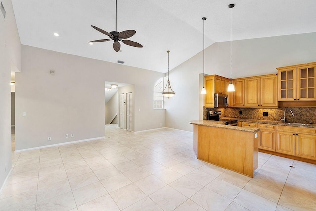 kitchen with sink, stone countertops, hanging light fixtures, appliances with stainless steel finishes, and backsplash