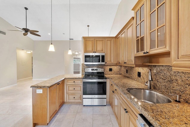 kitchen featuring lofted ceiling, pendant lighting, light stone countertops, and appliances with stainless steel finishes