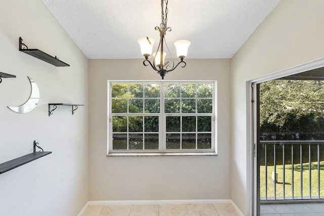 unfurnished dining area with a notable chandelier, a textured ceiling, and light tile patterned floors