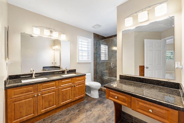 bathroom with vanity, toilet, and an enclosed shower