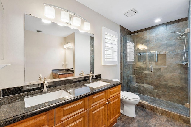 bathroom with vanity, toilet, and an enclosed shower