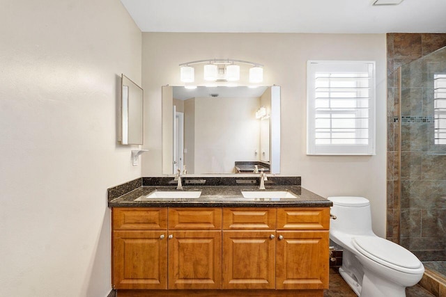 bathroom featuring an enclosed shower, vanity, and toilet