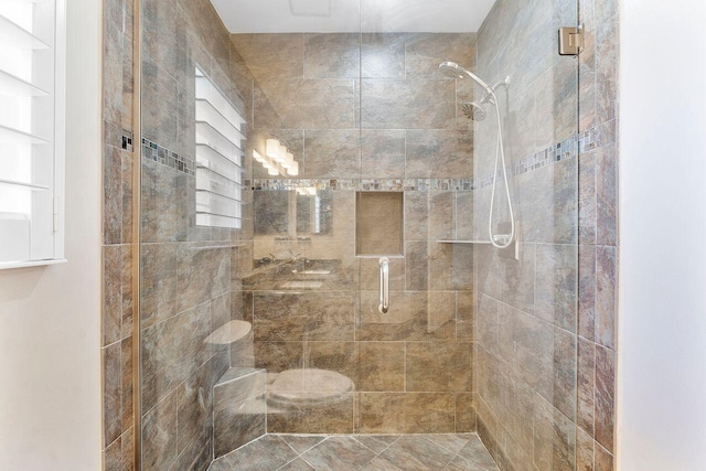 bathroom with a shower with door